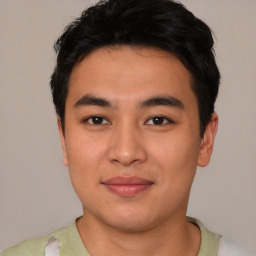 Joyful latino young-adult male with short  brown hair and brown eyes