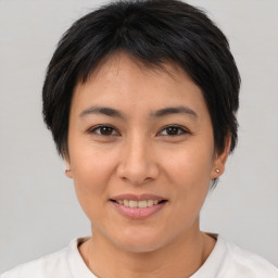 Joyful asian young-adult female with short  brown hair and brown eyes