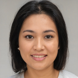 Joyful asian young-adult female with medium  brown hair and brown eyes