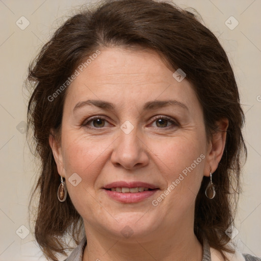 Joyful white adult female with medium  brown hair and grey eyes