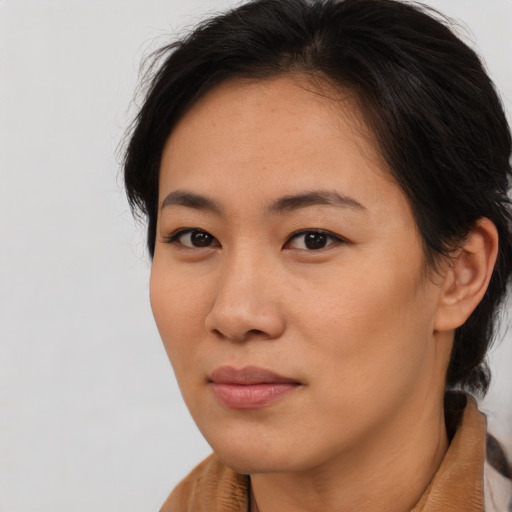 Joyful asian young-adult female with medium  brown hair and brown eyes