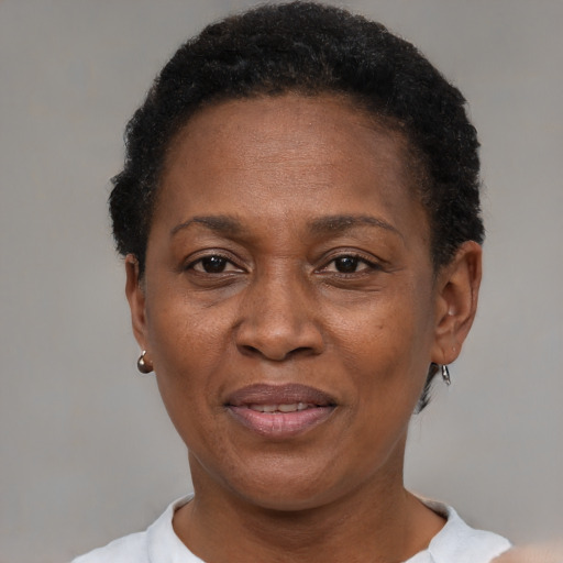 Joyful black adult female with short  brown hair and brown eyes