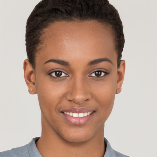 Joyful black young-adult female with short  brown hair and brown eyes