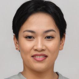 Joyful asian young-adult female with short  black hair and brown eyes