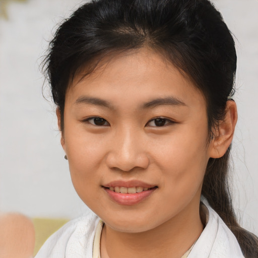 Joyful asian young-adult female with short  brown hair and brown eyes