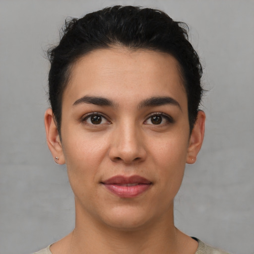 Joyful latino young-adult female with short  brown hair and brown eyes