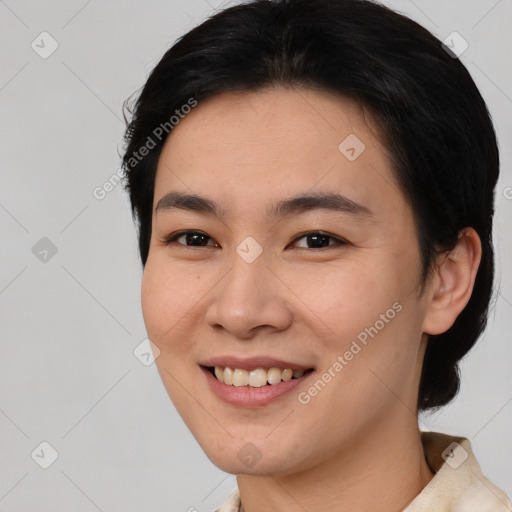 Joyful asian young-adult female with short  brown hair and brown eyes