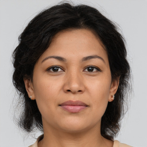 Joyful asian adult female with medium  brown hair and brown eyes