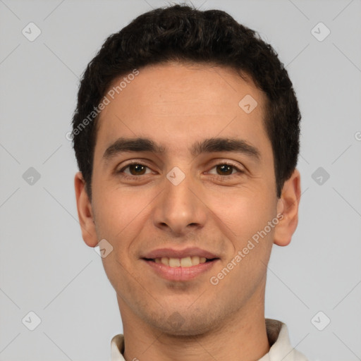 Joyful white young-adult male with short  black hair and brown eyes