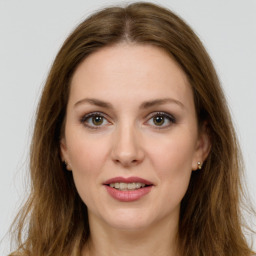 Joyful white young-adult female with long  brown hair and green eyes