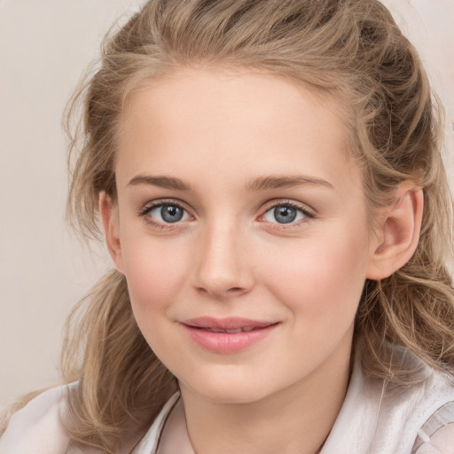 Joyful white child female with medium  brown hair and grey eyes