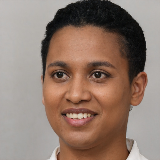 Joyful black young-adult female with short  black hair and brown eyes