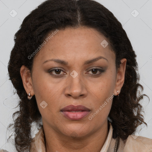 Joyful latino adult female with medium  brown hair and brown eyes
