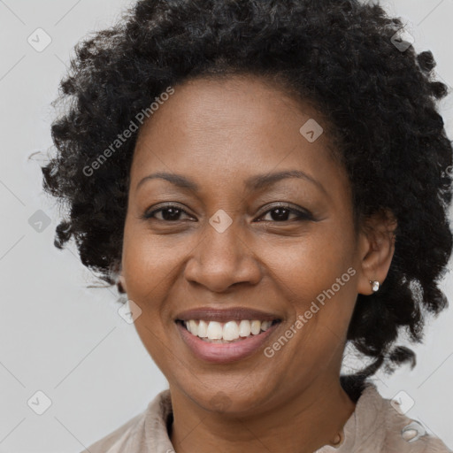 Joyful black adult female with short  brown hair and brown eyes