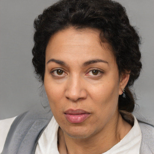 Joyful latino adult female with short  brown hair and brown eyes