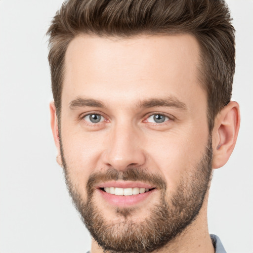 Joyful white young-adult male with short  brown hair and brown eyes