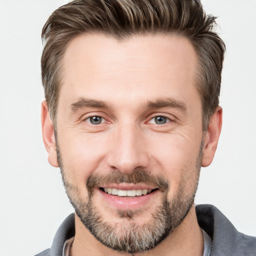 Joyful white adult male with short  brown hair and brown eyes