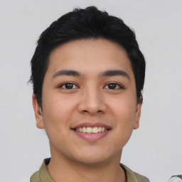 Joyful asian young-adult male with short  black hair and brown eyes