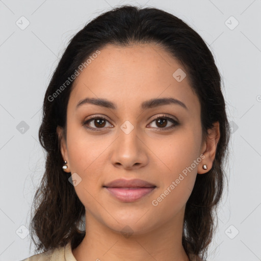 Joyful latino young-adult female with long  brown hair and brown eyes