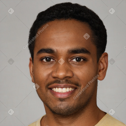 Joyful black young-adult male with short  black hair and brown eyes