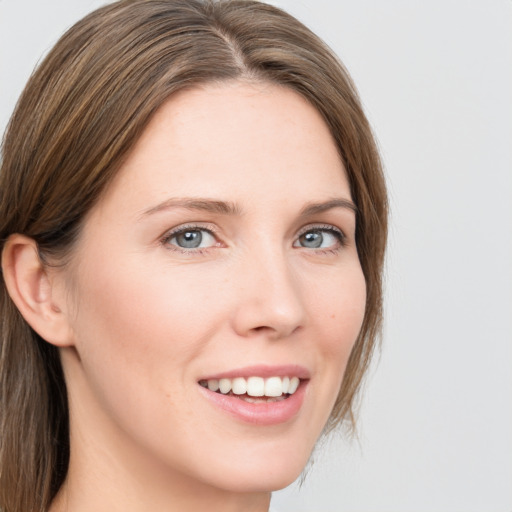 Joyful white young-adult female with medium  brown hair and grey eyes