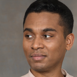 Joyful black young-adult male with short  black hair and brown eyes