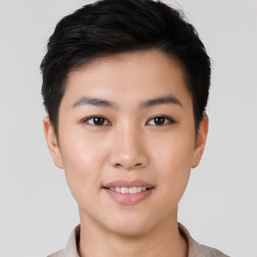 Joyful asian young-adult female with short  brown hair and brown eyes