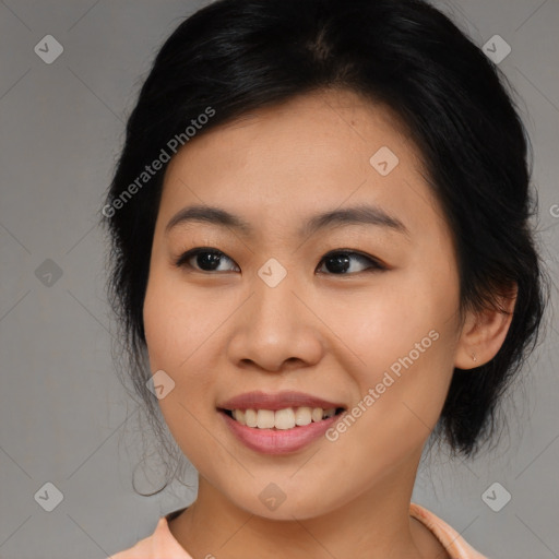 Joyful asian young-adult female with medium  black hair and brown eyes