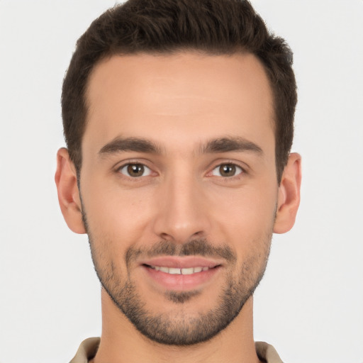 Joyful white young-adult male with short  brown hair and brown eyes