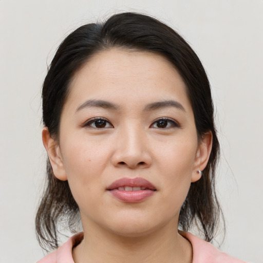 Joyful asian young-adult female with medium  brown hair and brown eyes