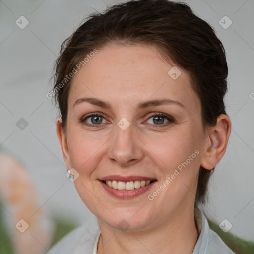 Joyful white adult female with medium  brown hair and grey eyes