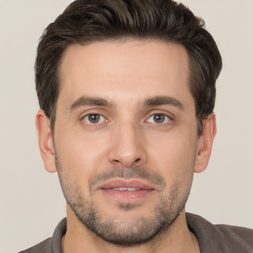 Joyful white young-adult male with short  brown hair and brown eyes