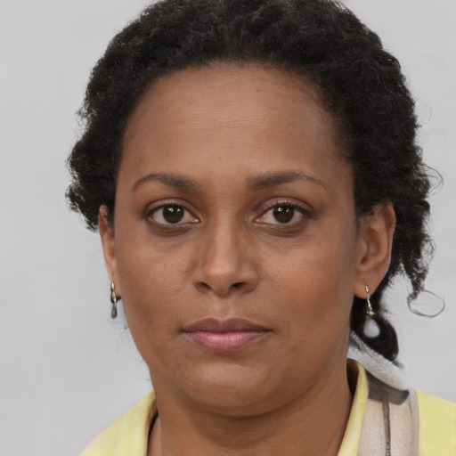 Neutral black adult female with short  brown hair and brown eyes