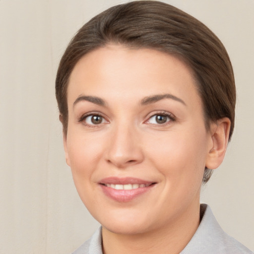 Joyful white young-adult female with short  brown hair and brown eyes