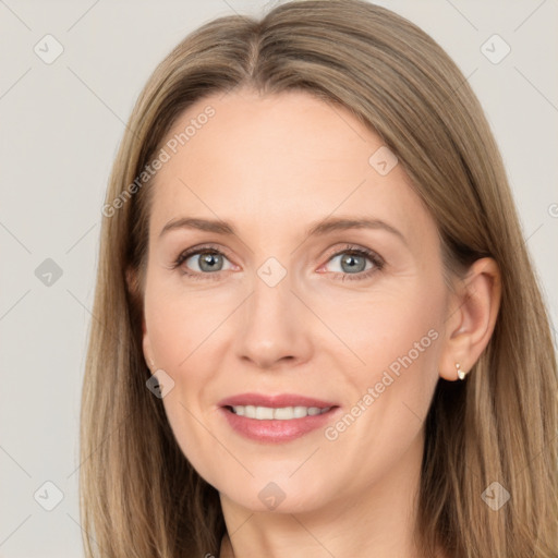 Joyful white adult female with long  brown hair and grey eyes