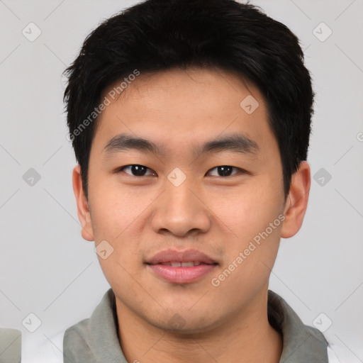 Joyful asian young-adult male with short  black hair and brown eyes