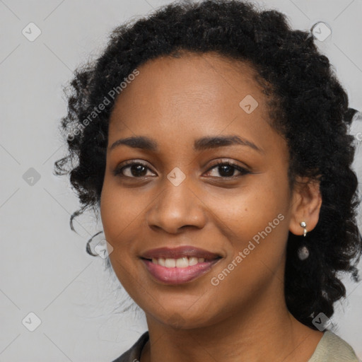 Joyful black young-adult female with long  black hair and brown eyes