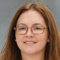 Joyful white adult female with long  brown hair and brown eyes