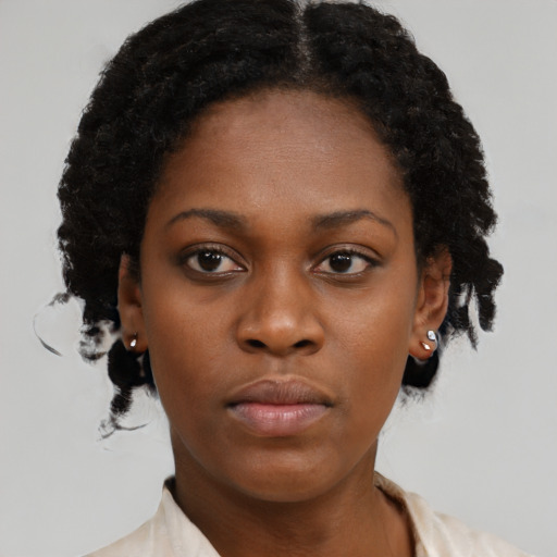 Neutral black young-adult female with medium  brown hair and brown eyes