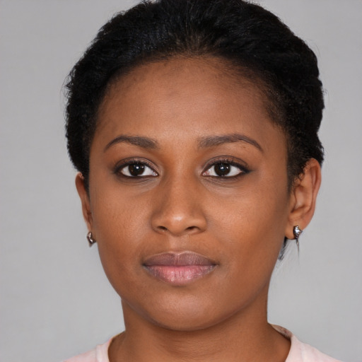 Joyful black young-adult female with short  brown hair and brown eyes