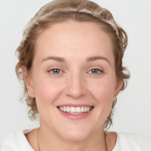 Joyful white young-adult female with medium  brown hair and blue eyes