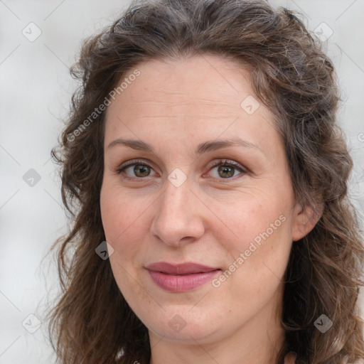 Joyful white adult female with long  brown hair and brown eyes