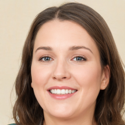 Joyful white young-adult female with medium  brown hair and green eyes