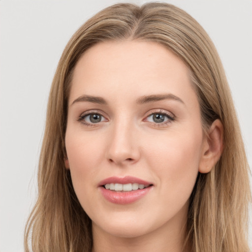 Joyful white young-adult female with long  brown hair and grey eyes