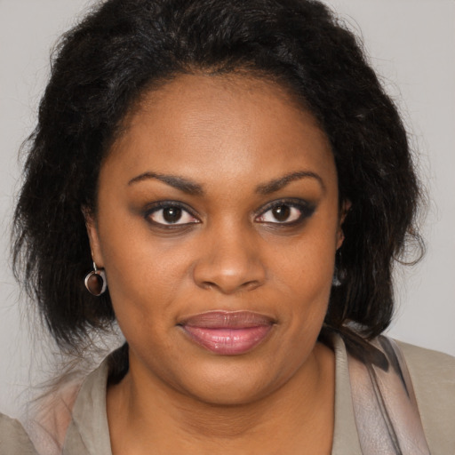 Joyful black young-adult female with medium  brown hair and brown eyes