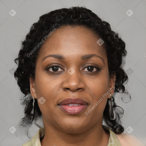 Joyful black adult female with medium  brown hair and brown eyes