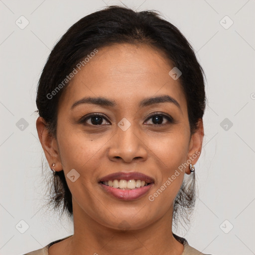 Joyful latino young-adult female with medium  brown hair and brown eyes