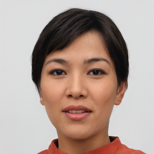 Joyful asian young-adult female with short  black hair and brown eyes
