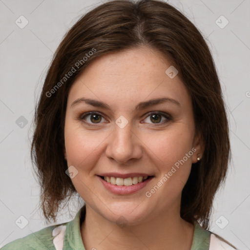 Joyful white young-adult female with medium  brown hair and green eyes