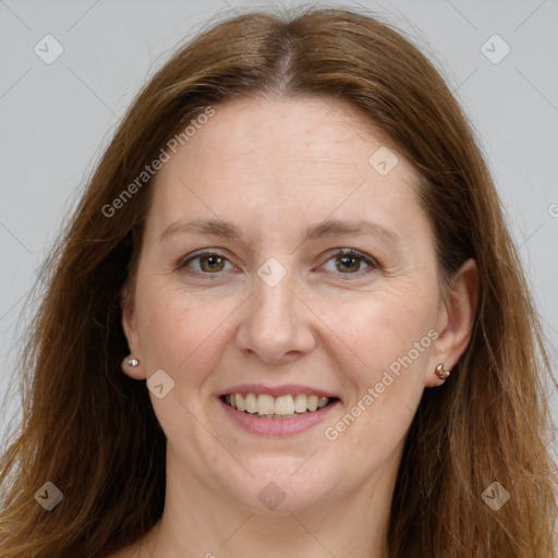 Joyful white adult female with long  brown hair and grey eyes